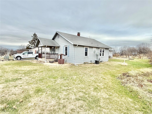 view of home's exterior featuring a lawn, covered porch, and central AC