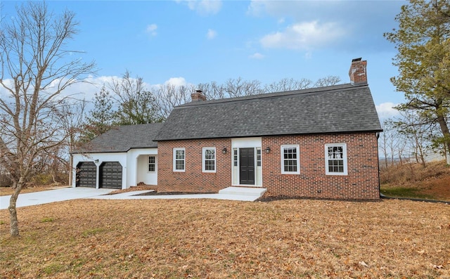 view of front of house with a garage and a front yard