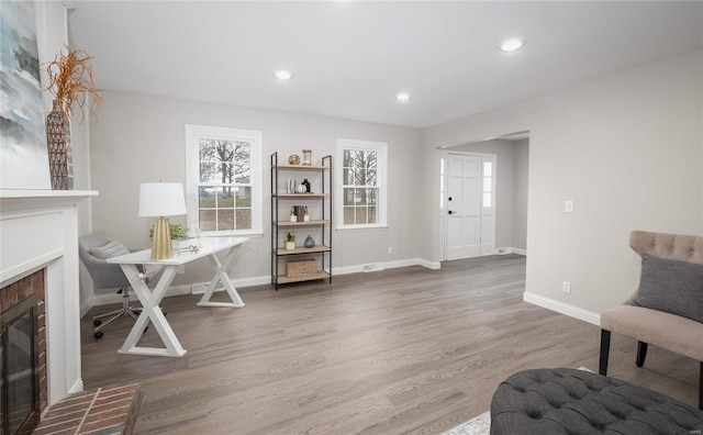 office space with hardwood / wood-style floors and a fireplace