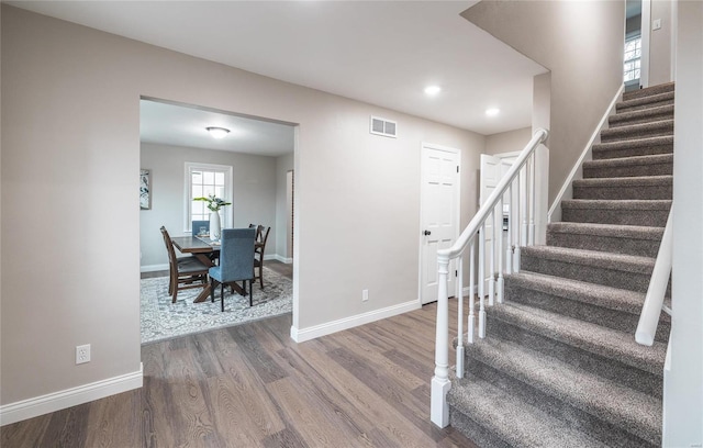 stairway with hardwood / wood-style flooring