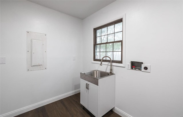 clothes washing area featuring cabinets, washer hookup, electric dryer hookup, sink, and electric panel