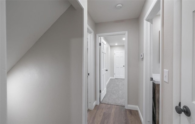 hallway with light hardwood / wood-style floors