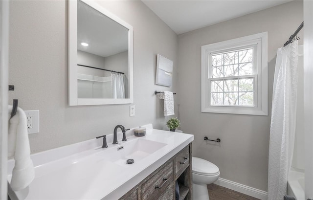 bathroom featuring a shower with curtain, vanity, hardwood / wood-style flooring, and toilet