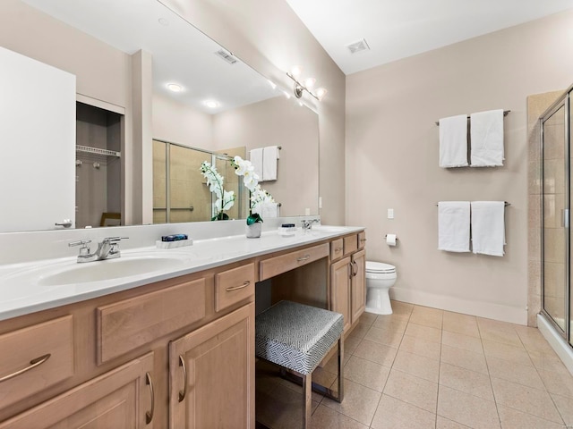 bathroom featuring tile patterned floors, toilet, vanity, and walk in shower