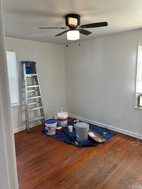 miscellaneous room with ceiling fan and dark wood-type flooring