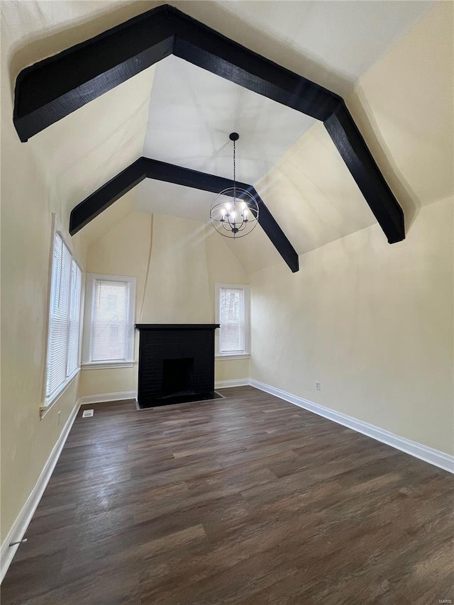 unfurnished living room with a fireplace, vaulted ceiling, an inviting chandelier, and dark wood-type flooring