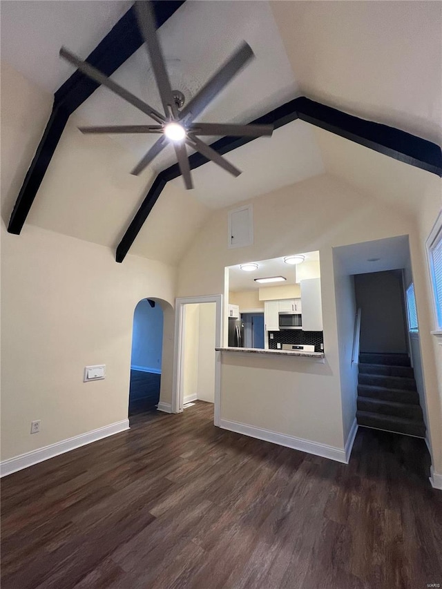 unfurnished living room featuring lofted ceiling with beams, ceiling fan, and dark hardwood / wood-style flooring