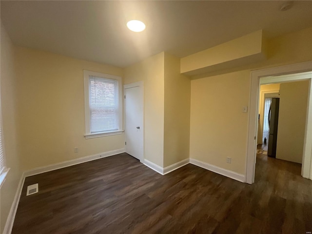 empty room with dark wood-type flooring