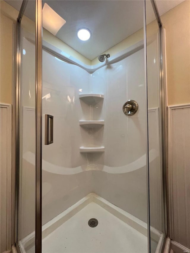 bathroom with a shower with shower door