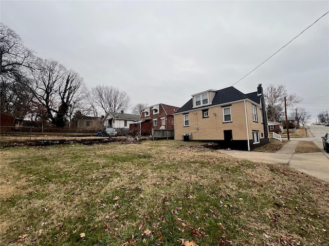 view of home's exterior with a yard and cooling unit