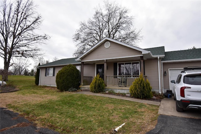 single story home featuring covered porch, a garage, and a front yard