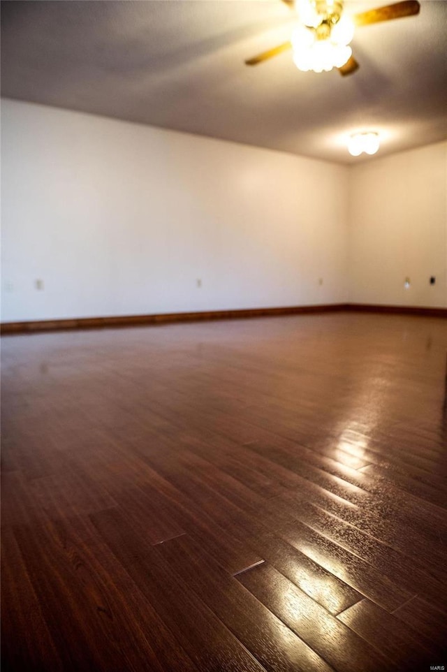 unfurnished room featuring ceiling fan and dark hardwood / wood-style flooring