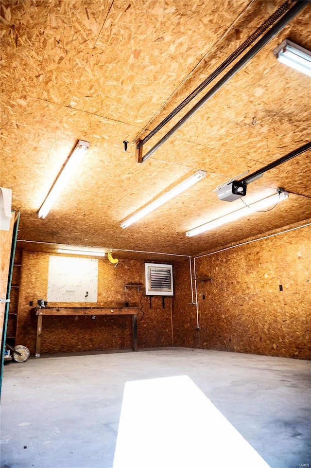 garage with a workshop area and a garage door opener