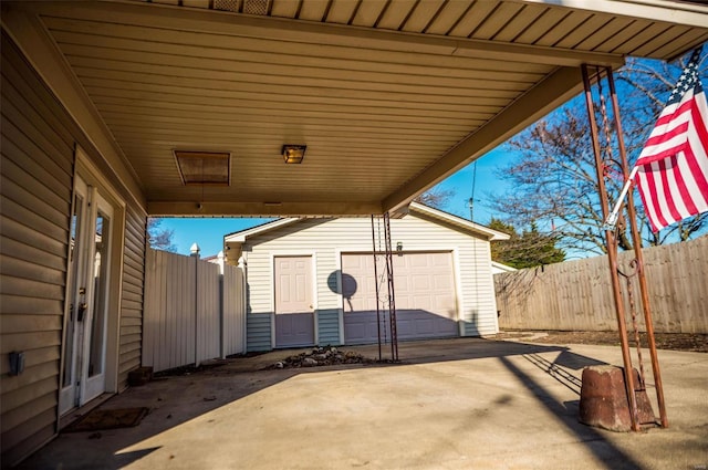 view of patio / terrace with a garage and an outdoor structure