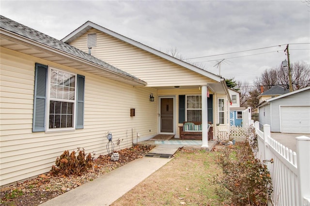 bungalow-style house featuring an outbuilding and covered porch