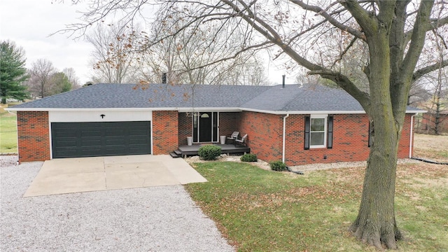 ranch-style house featuring a front lawn and a garage