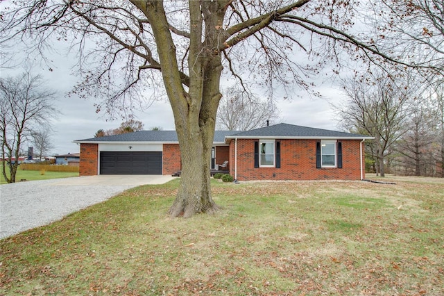 ranch-style home featuring a front yard and a garage