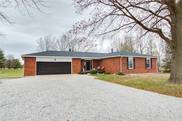 ranch-style home with a garage and a front lawn