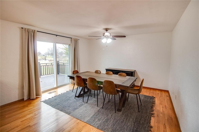 dining space featuring light hardwood / wood-style flooring and ceiling fan