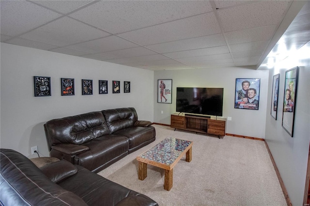 living room featuring a paneled ceiling and carpet flooring