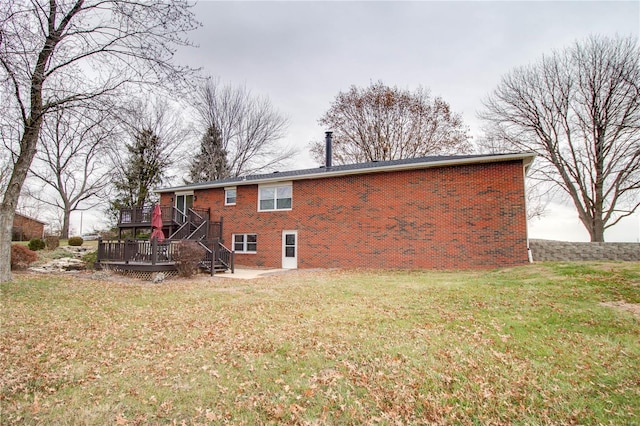 rear view of house with a yard and a wooden deck