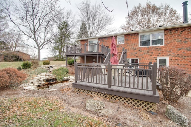 rear view of property featuring a wooden deck