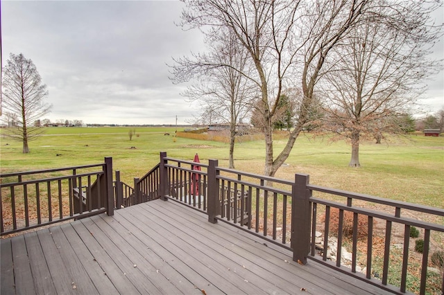 wooden deck featuring a yard and a rural view