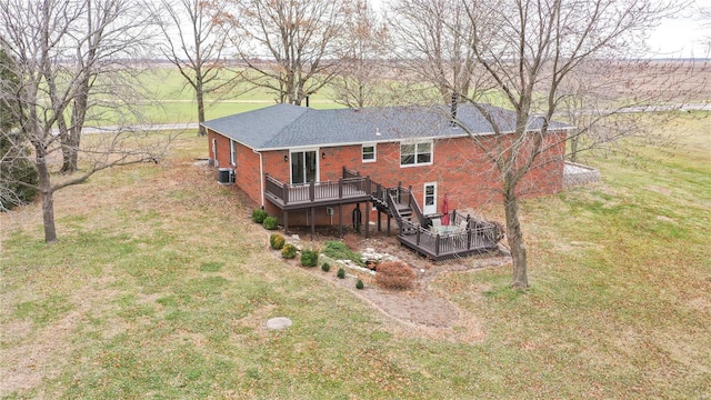 rear view of house featuring a lawn, central air condition unit, and a deck