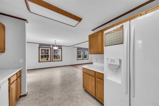 kitchen featuring a textured ceiling, decorative light fixtures, white appliances, and ornamental molding