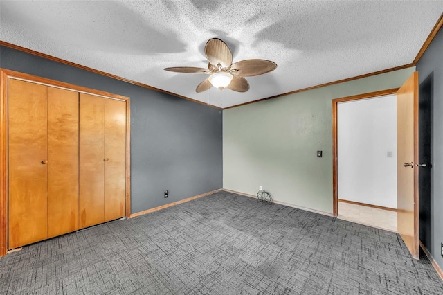 unfurnished bedroom featuring ceiling fan, dark carpet, a textured ceiling, and a closet