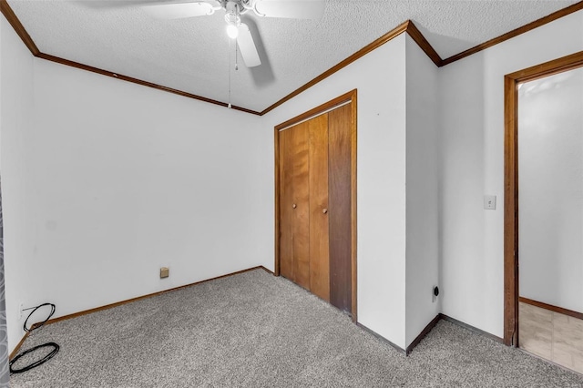 unfurnished bedroom with ceiling fan, a closet, light colored carpet, and a textured ceiling