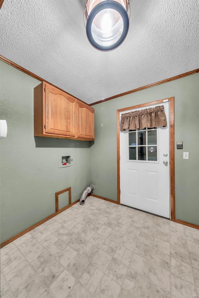 laundry area with cabinets, washer hookup, a textured ceiling, and ornamental molding