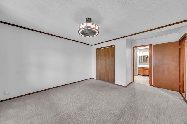 unfurnished bedroom with a closet, light colored carpet, and a textured ceiling