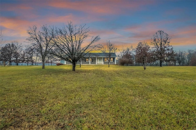 view of yard at dusk