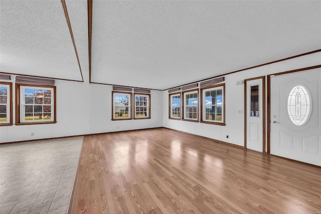 entrance foyer featuring light hardwood / wood-style floors and a textured ceiling