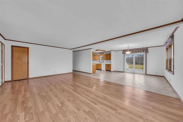 unfurnished living room featuring crown molding and light hardwood / wood-style flooring