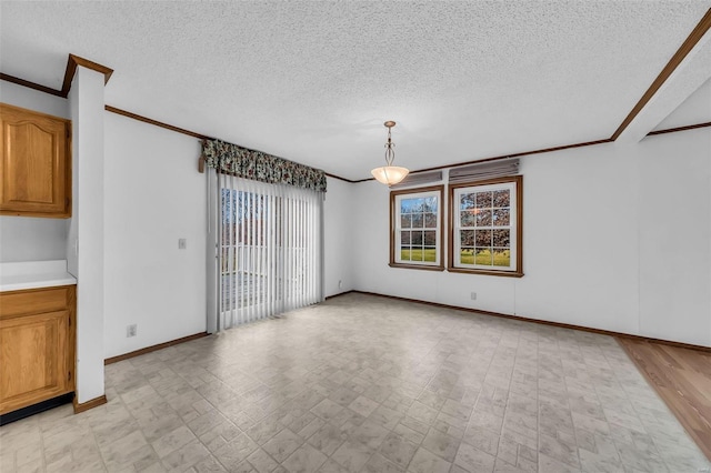 unfurnished dining area featuring a textured ceiling and ornamental molding