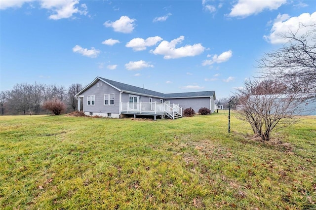 rear view of house with a lawn and a wooden deck