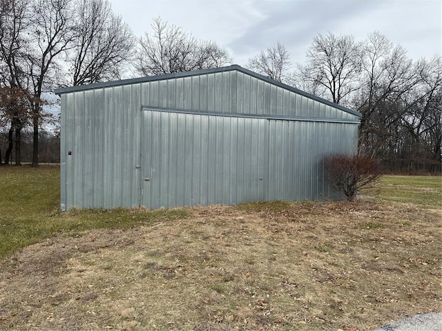 view of outbuilding featuring a lawn