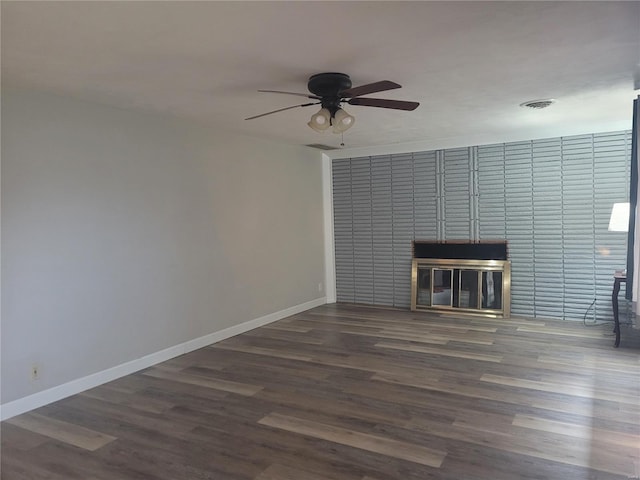 unfurnished living room with dark hardwood / wood-style floors and ceiling fan