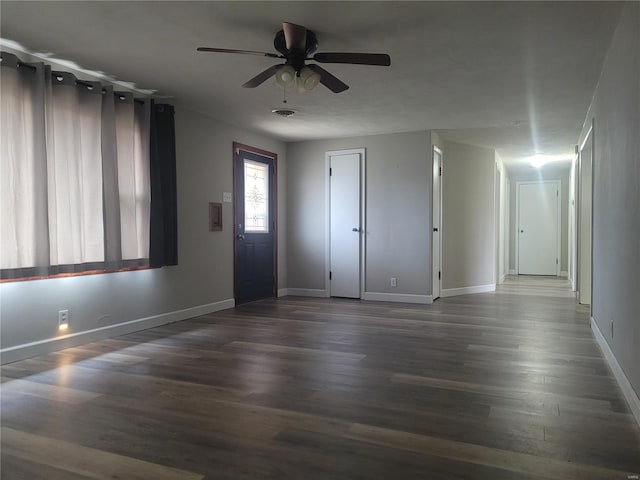 interior space with ceiling fan and dark hardwood / wood-style floors