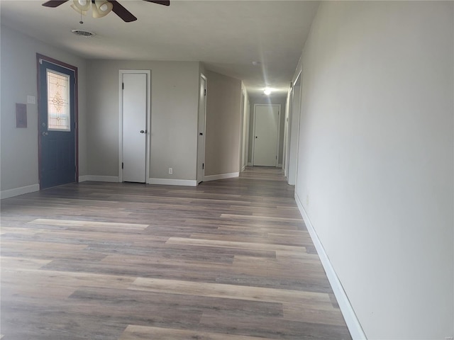 empty room featuring ceiling fan and light hardwood / wood-style flooring