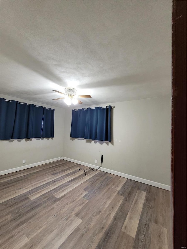 spare room featuring hardwood / wood-style flooring and a textured ceiling