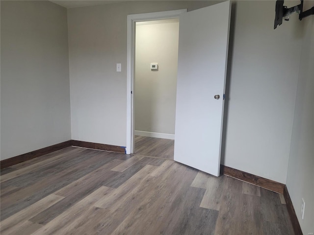 unfurnished room with hardwood / wood-style flooring