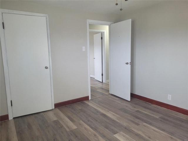 unfurnished bedroom with hardwood / wood-style flooring