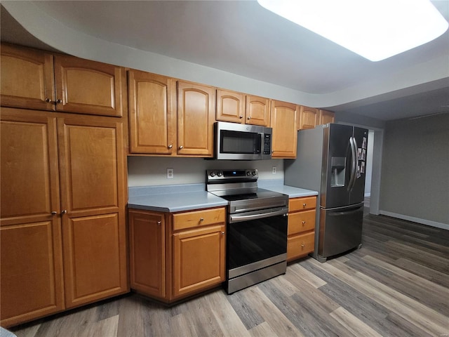 kitchen with stainless steel appliances and light wood-type flooring