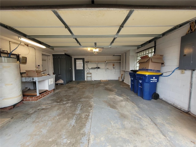 garage with electric panel, water heater, and a garage door opener