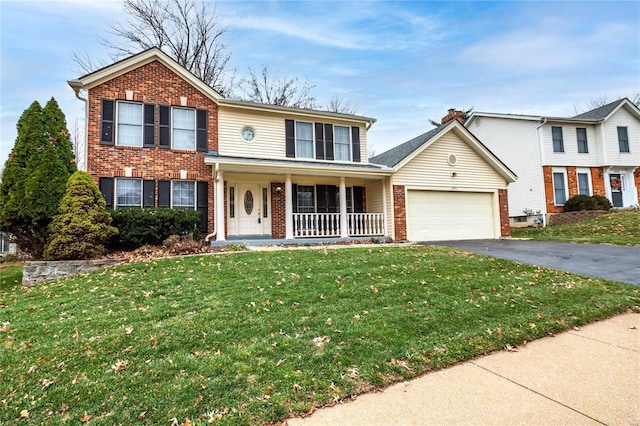 view of front of property featuring a porch, a garage, and a front lawn