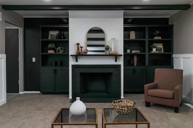 carpeted living room with beamed ceiling and built in features