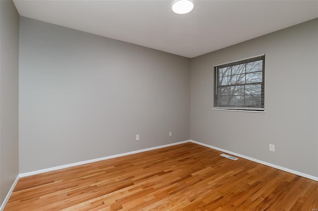 spare room with light hardwood / wood-style flooring